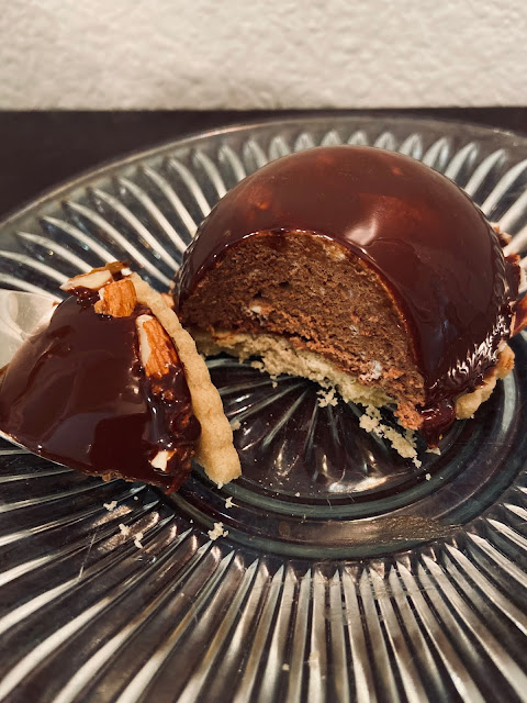 chocolate mousse dome with fork and bite